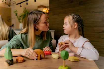A child with SEND is playing with their carer